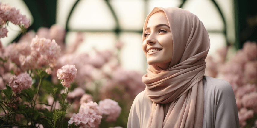 Confident Muslim woman wearing a hijab, smiling in a sunny, floral-filled atmosphere, radiating comfort and modesty.